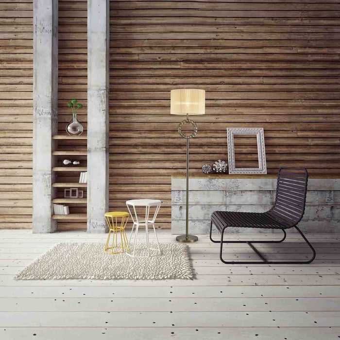 Tall floor lamp with drum shade and crystal ring detail in a loft-style room with wood panel wall and modern seating.