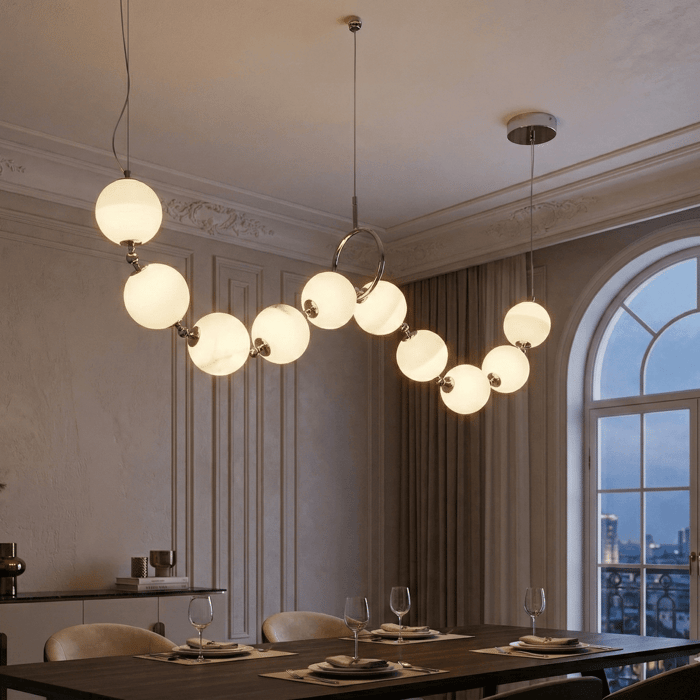 Modern dining room with globe pendant dining room lights over rectangular wooden table.