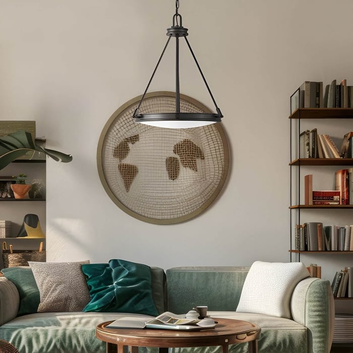 Modern living room with dark metal pendant & globe art above green velvet sofa
