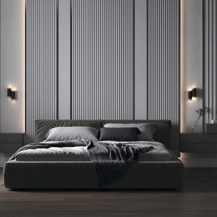 Sleek black cylindrical wall sconces flanking a large upholstered bed in a gray-toned modern bedroom.