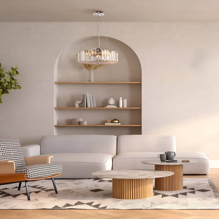 Minimalist living room with arched wall niche, round glass chandelier, neutral palette, and sculptural wood coffee tables.