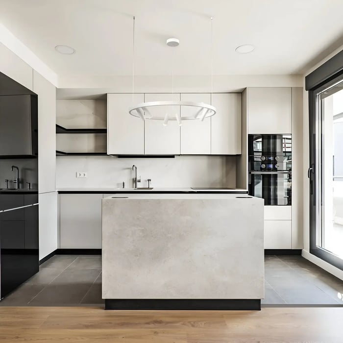 A futuristic twist on simplicity, featuring a suspended circular light that stands out as the kitchen’s modern centerpiece.
