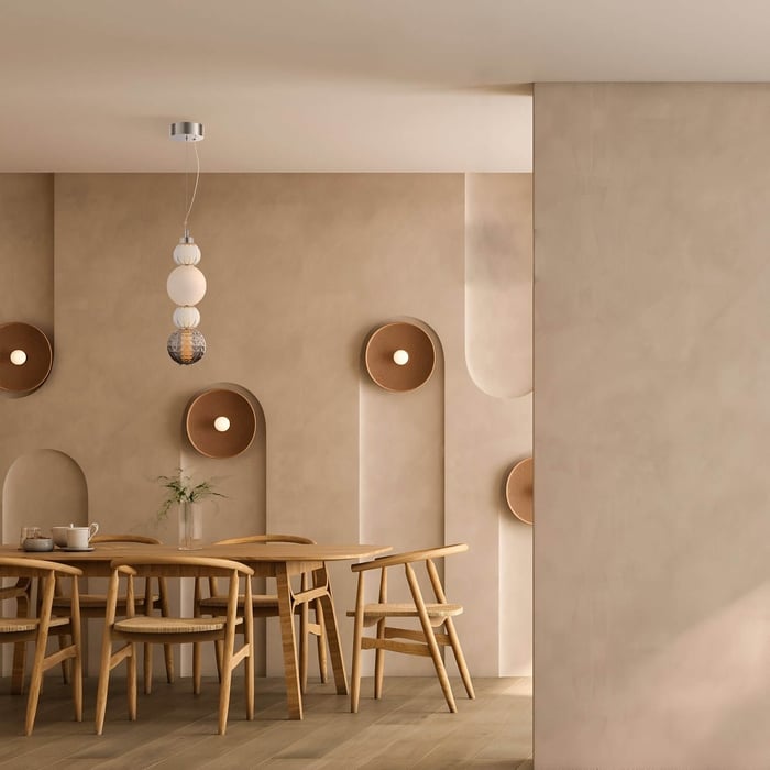 Scandi-style dining space with layered orb pendant & sculpted beige wall lights