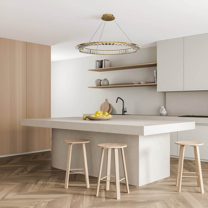 Minimalist kitchen with pale wood bar stools, open shelving, and a gold-rimmed crystal chandelier above a large central island.