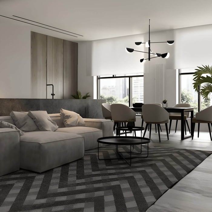 Black sculptural chandelier with angled shades above a gray sectional and dining area in a modern apartment.