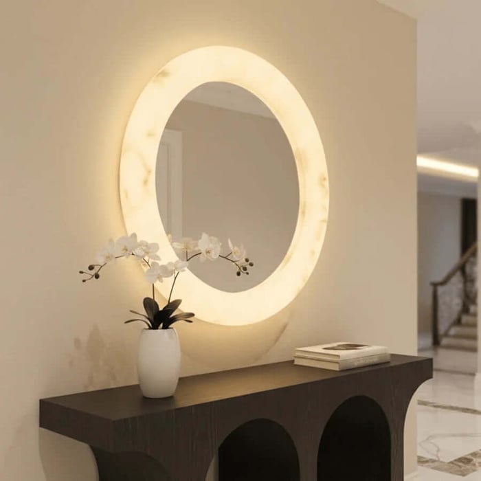 Modern hallway console styled with glowing alabaster mirror and decorative orchid.