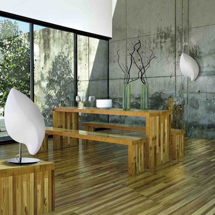 Contemporary dining nook with wooden table, large windows, and sculptural white wall lights.