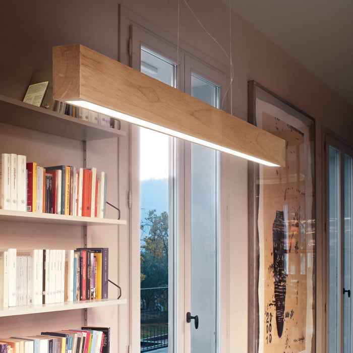 Natural wood beam pendant light with built-in linear illumination, perfect for modern home offices.