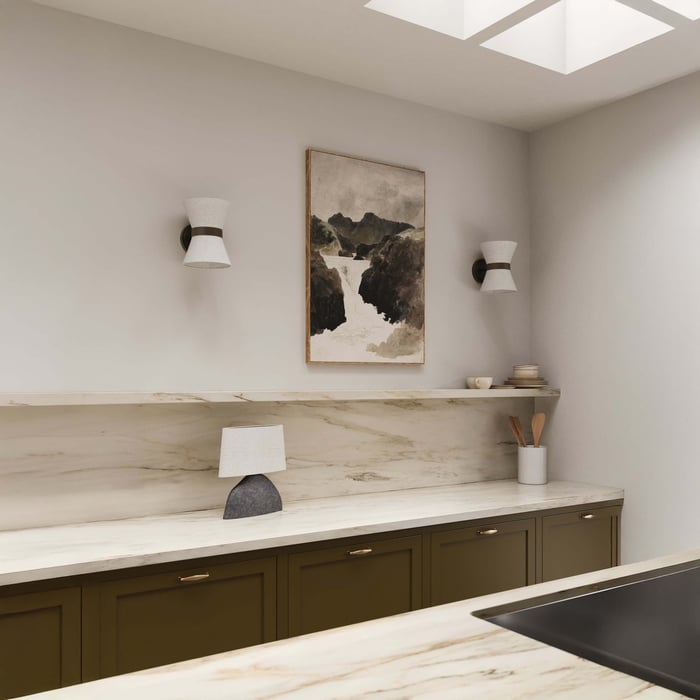 White conical wall sconces with black mounts above marble backsplash and olive green cabinetry in a minimalist kitchen.
