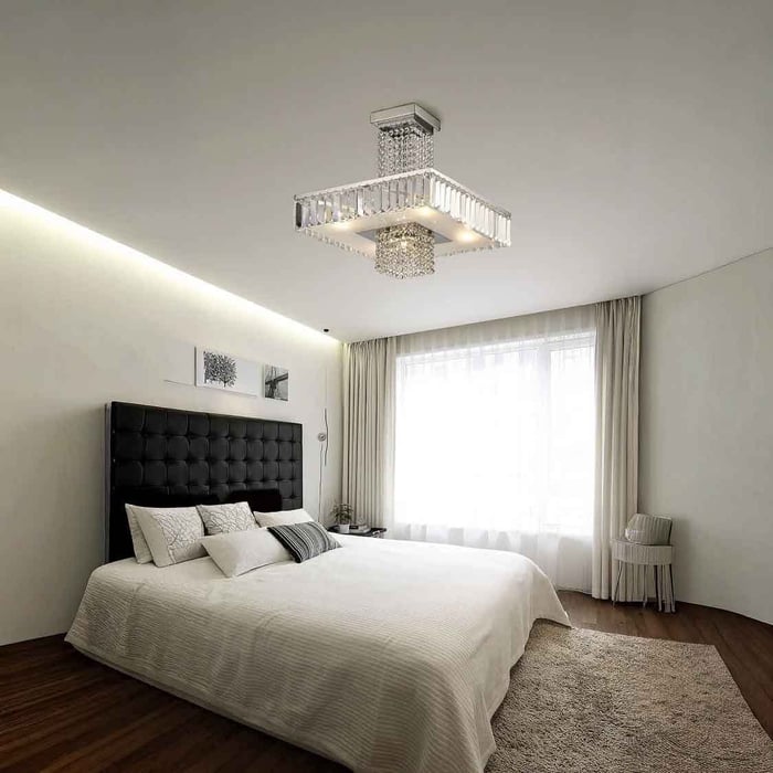 Light, neutral bedroom with a crystal-style flush ceiling fitting and soft daylight, balanced with calm ambient lighting.