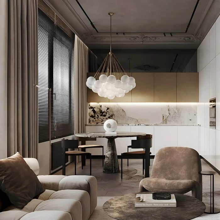 Modern open-plan dining area with cloud-style glass chandelier above a round table.