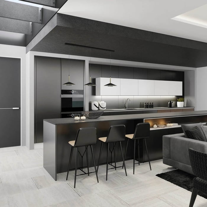 Dark modern open-plan kitchen with a long black island, bar stools, and small black pendant lights above the counter.