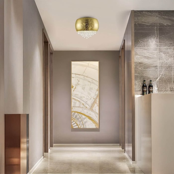 Gold dome ceiling fixture with cascading crystals in a hallway.