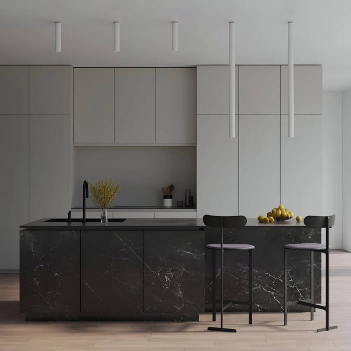 Minimalist modern kitchen with a black marble island and slim white tube ceiling lights suspended above the worktop and breakfast bar.