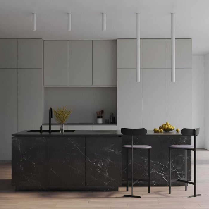 Modern minimalist kitchen with black marble island, tall white cylindrical pendant lights, and sleek grey cabinetry.