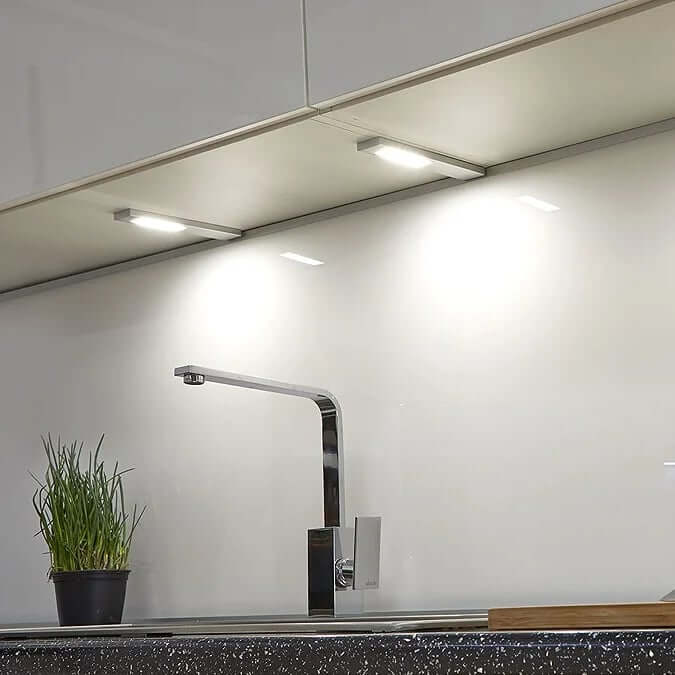 Slim under-cabinet LED fitting providing focused task lighting along a kitchen worktop.