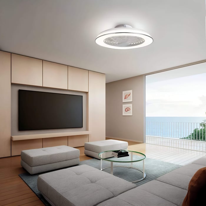 Modern lounge with flush ceiling fan light, wall-mounted TV, and balcony doors with sea view.