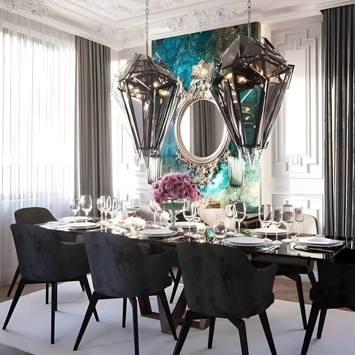Two smoked glass sculptural pendants hanging above a formal dining table with place settings.