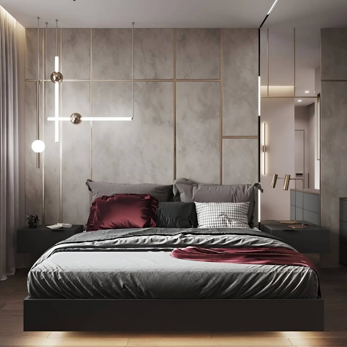 Minimalist bedroom with a modern LED suspension light and integrated wall lighting above a neatly styled bed.