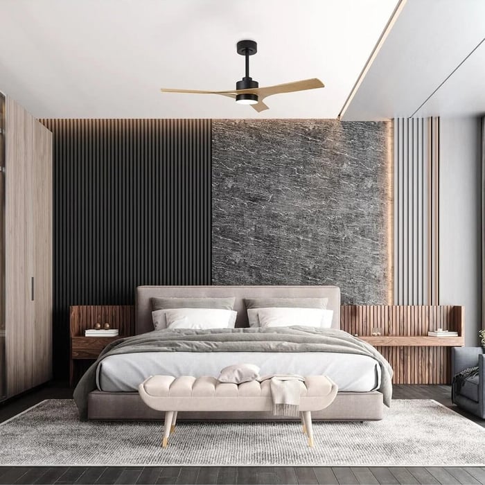Minimalist living room with white ceiling fan light, panelled feature wall, and modern armchairs.