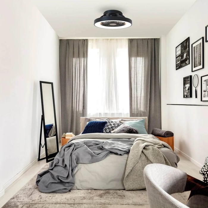 Bright minimalist bedroom with black flush ceiling fan light, neutral bedding, and full-length mirror.