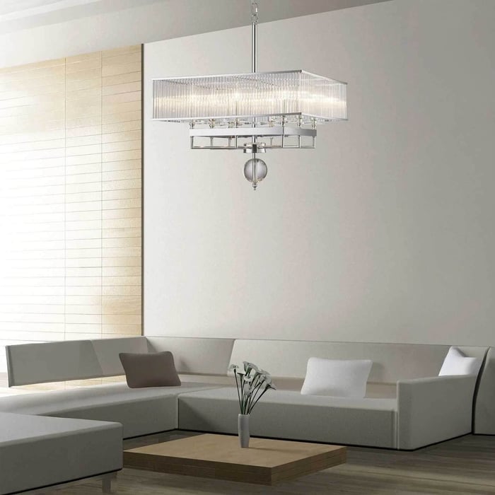 Modern rectangular crystal modern chandeliers in chrome, suspended over a light grey sectional sofa in a contemporary living room.