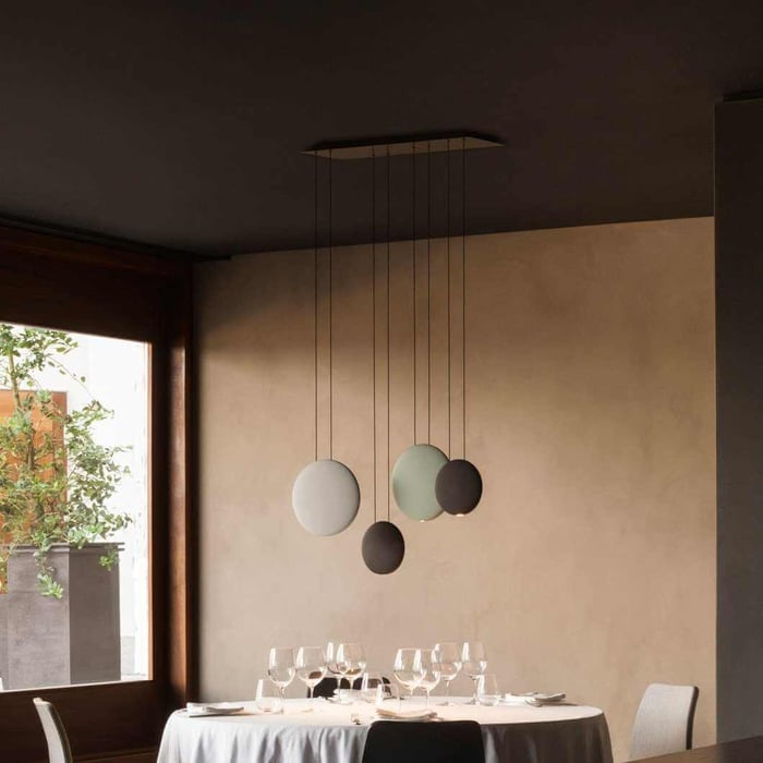 This pendant light showcases floating discs in muted tones, adding an artistic touch. Ideal for dining rooms or lounges, it delivers ambient lights with a modern aesthetic.