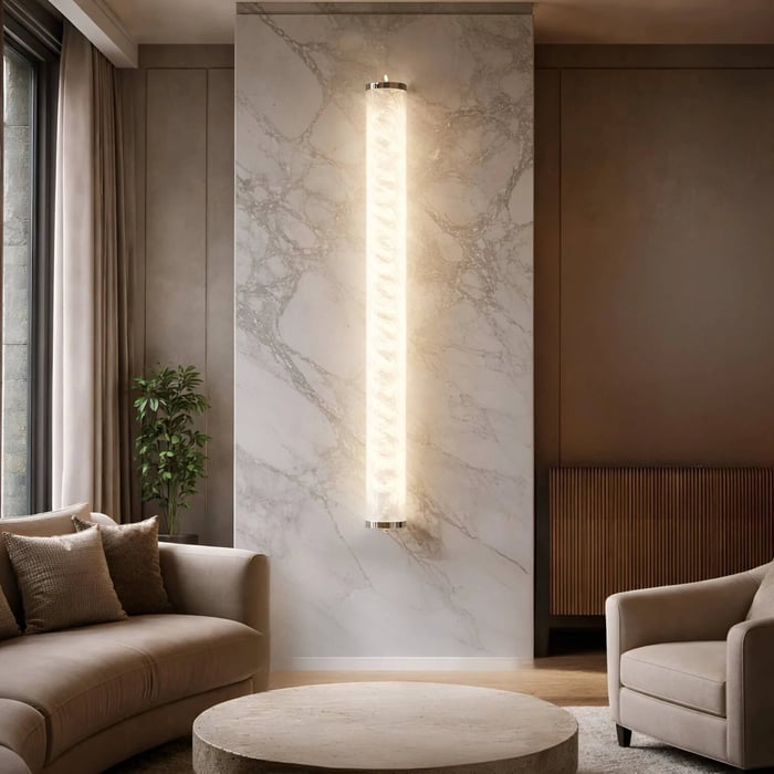 Contemporary seating area with a marble feature wall and a glowing vertical wall light centered between two sofas.