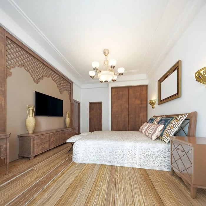 Classic bedroom with gold chandelier, carved wall design, and warm wood furniture.