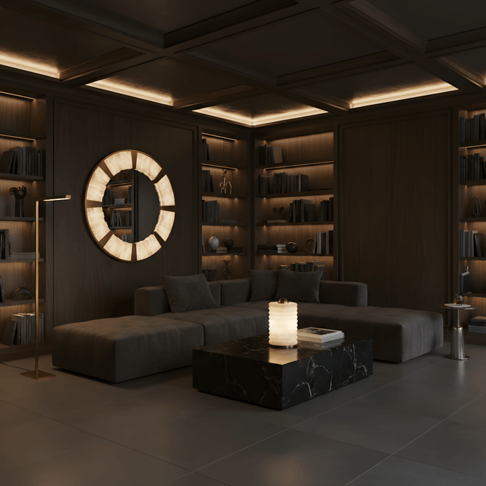Dark wood living room with built-in shelving and a circular illuminated alabaster wall feature above a modern sofa.
