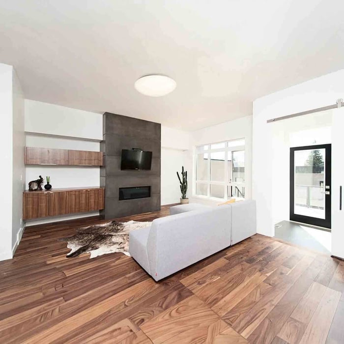 Classic white flush mount ceiling light in a cozy living room with fireplace.