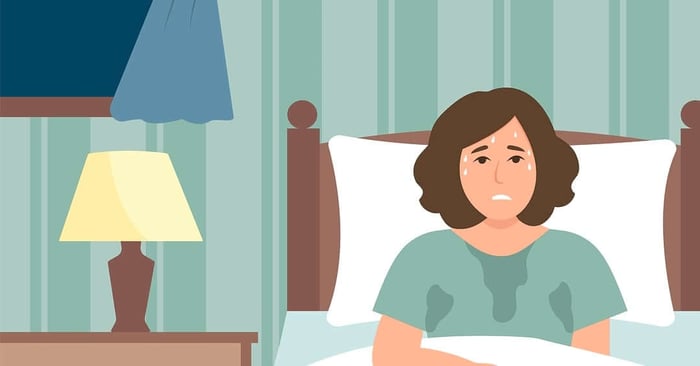 Illustration of a woman sitting up in bed overheating and sweating, showing night sweats in women.