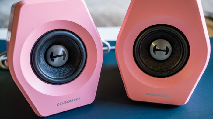 Edifier G2000 speakers in pink on a table