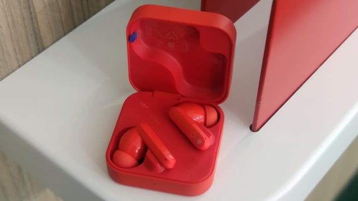 CMF Buds Pro 2 bold orange earbuds on white and orange background