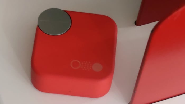 CMF Buds Pro 2 side view on white and orange background