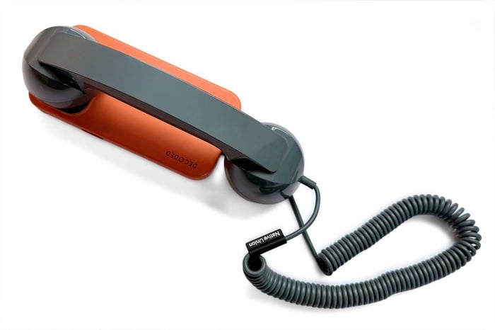 Native Union POP handset in bright green and orange paired with an iPhone