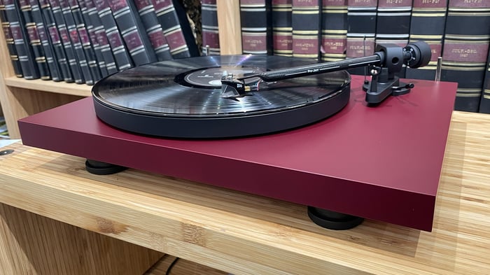 Pro-Ject Debut Evo 2 turntable on wooden hi-fi rack