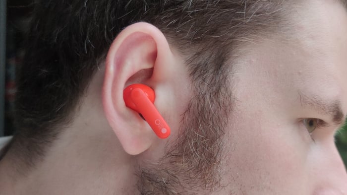 CMF Buds Pro 2 close-up on bright orange background