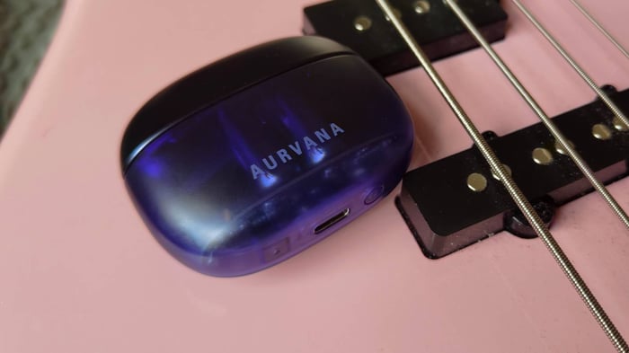 Creative Aurvana Ace 3 case on a pink bass guitar