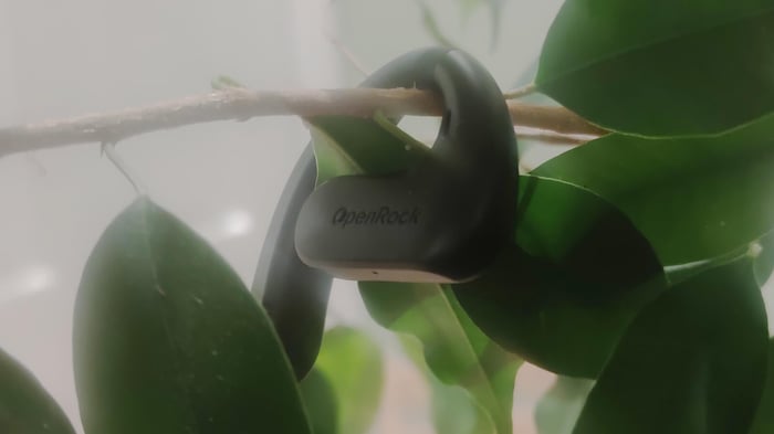 A close look at a single OpenRock S earbud.