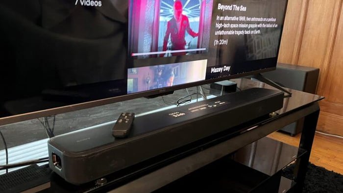 Sony HT-S2000 sitting below a TV with Netflix on-screen.