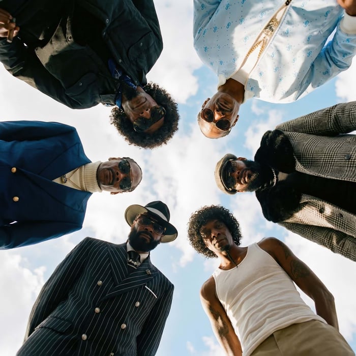 Album cover showing eight figures in black-and-white with red and blue accents