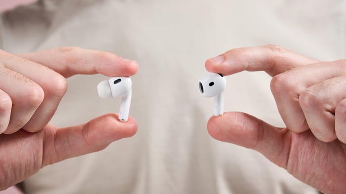 AirPods Pro 2 and AirPods 4 being held up next to each other