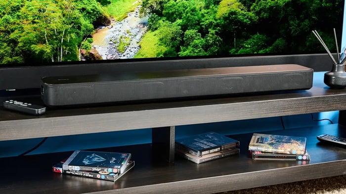 Minimalist design with a black metal grille wrapping the soundbar
