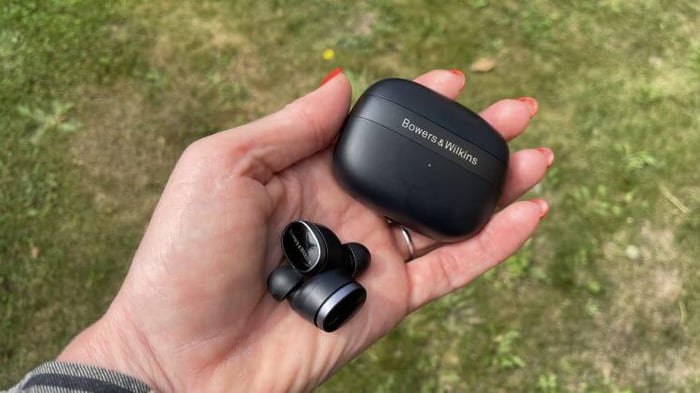 Bowers & Wilkins Pi8 earbuds held on grass