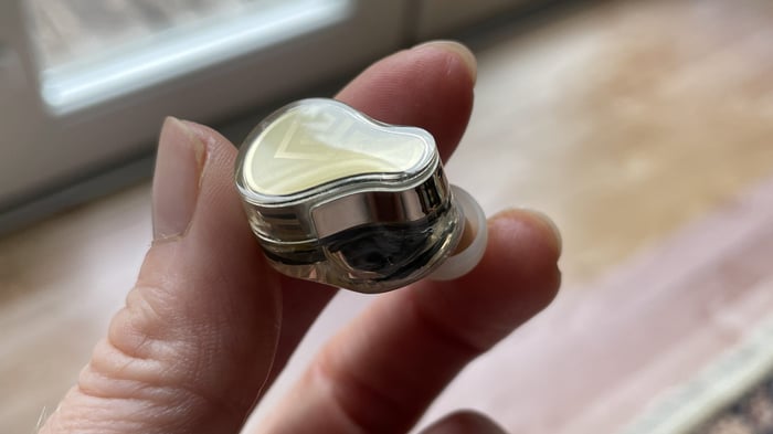 Close-up of the Soundpeats H3 earbuds with gold accents