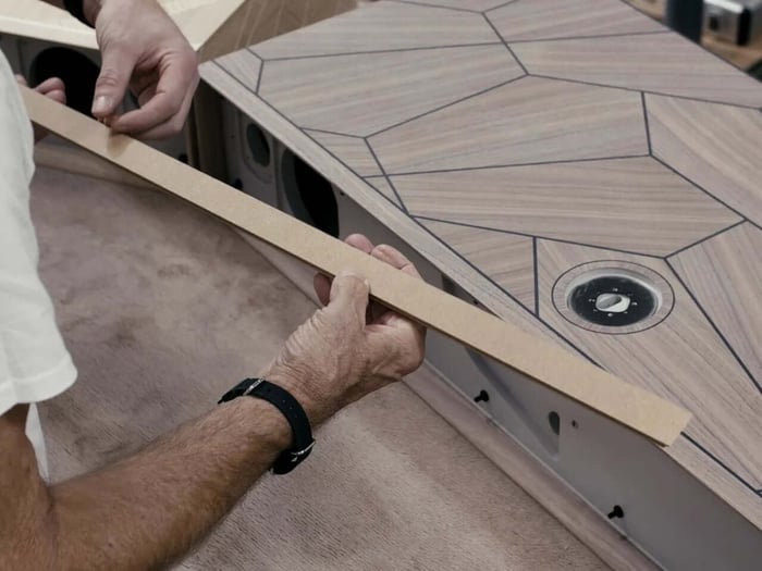 Glossy lacquer finish and chrome stand highlight the speaker’s refined design