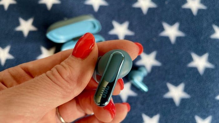 Close-up of JBL Live Beam 3 earbuds