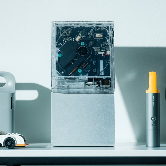 ClearFrame CD Player showcasing crystal-clear polycarbonate body framing album art