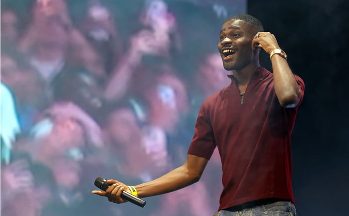 Dave performing live, credited to Simone Joyner/Getty Images